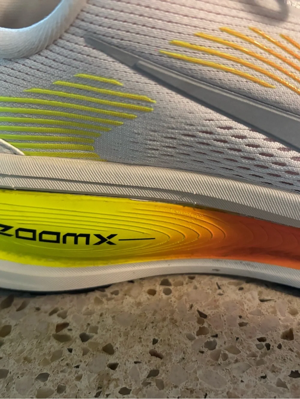 Nike White Volmero 18 Running Shoes with Neon Yellow-Orange Accent